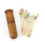 Treen needle box housing a collection of hand painted comical cocktail sticks, 13.5cm in length :