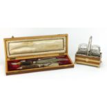 Horn handled carving set and a metal bound oak two bottle cruet stand with glass jars : For