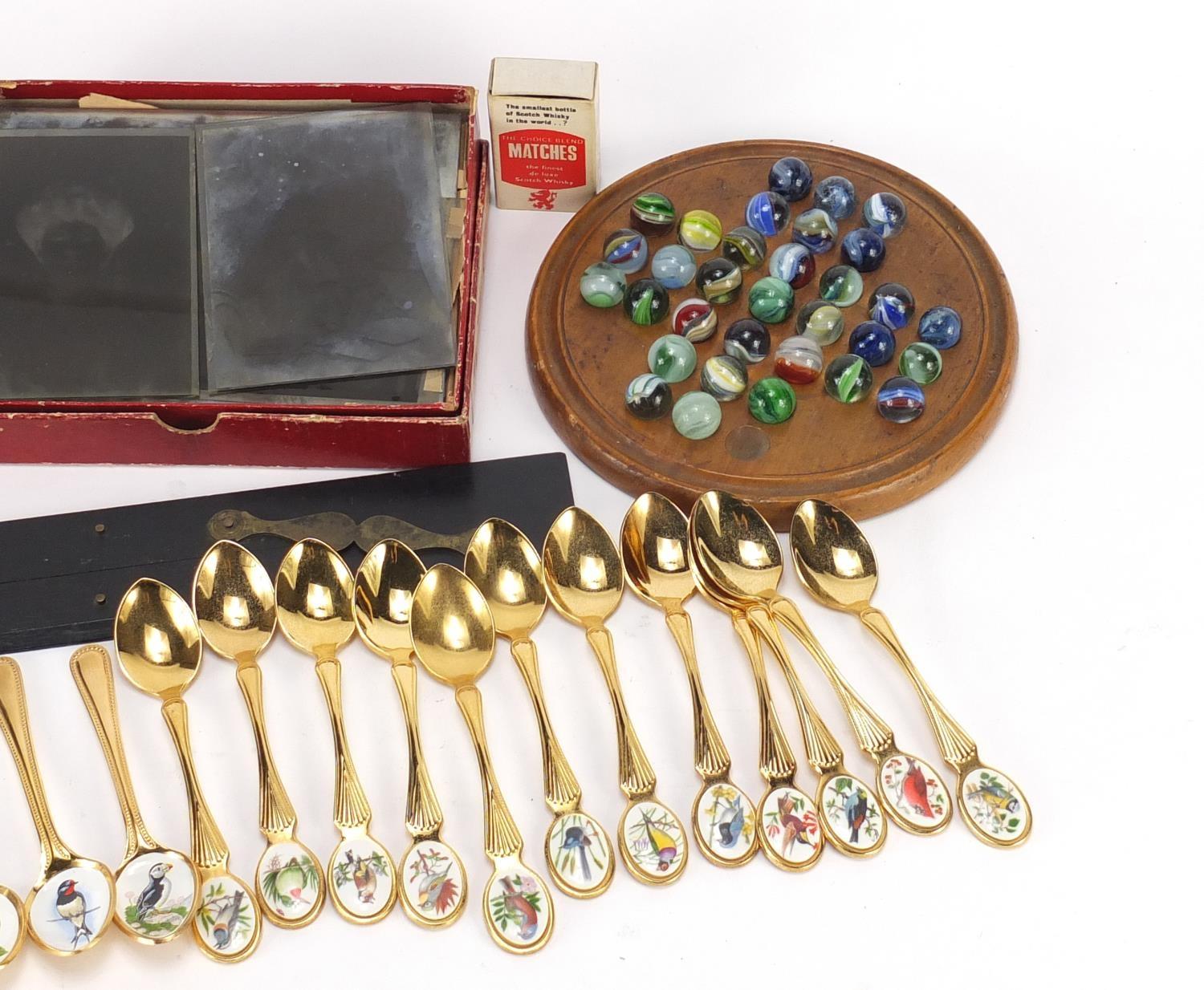Objects including birds of Britain collectors spoons, Victorian solitaire board with glass marbles - Image 3 of 3