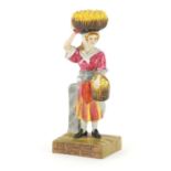 Staffordshire pottery figure of an orange seller, impressed Clarice Cliff to the reverse, 24cm