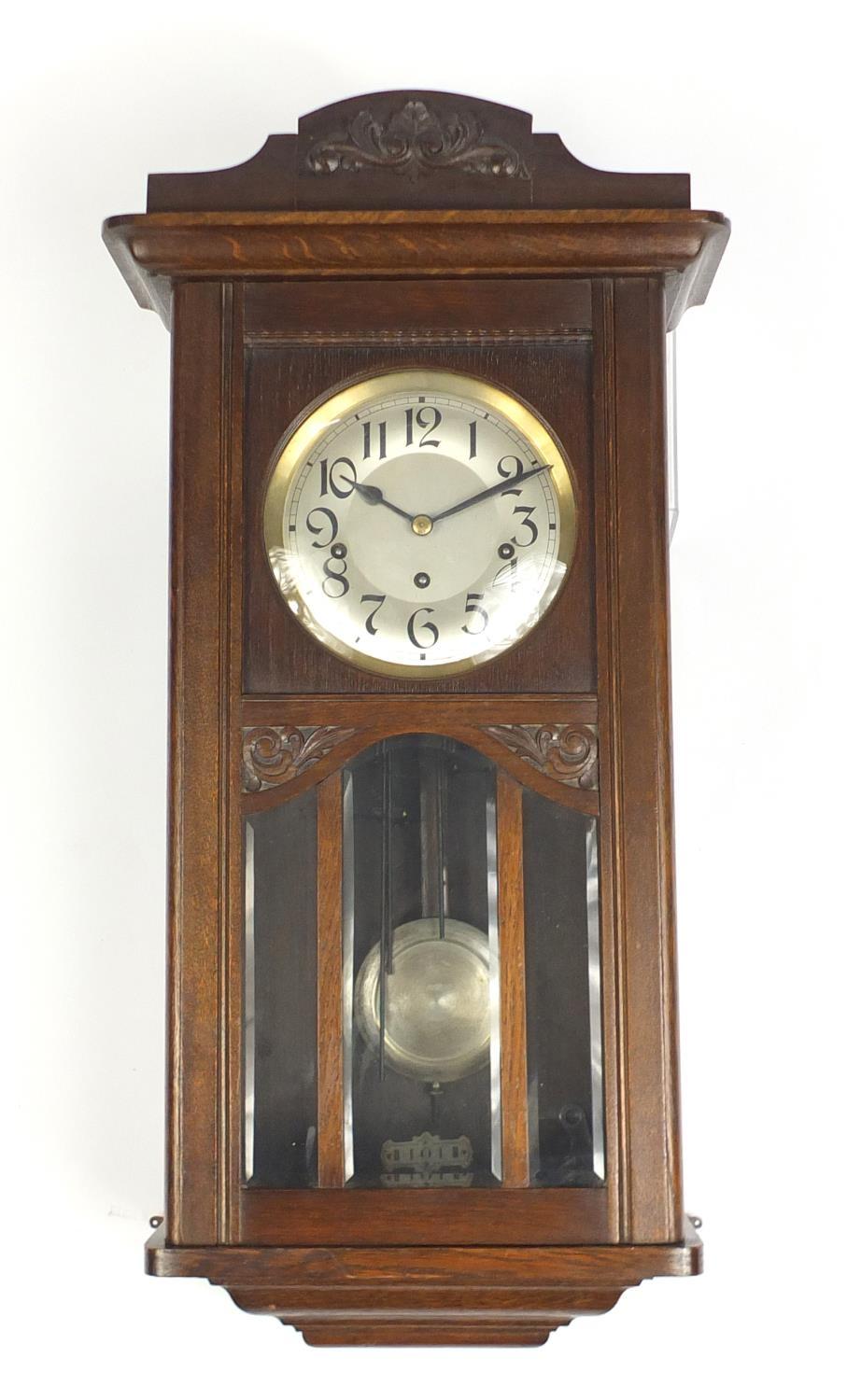 Oak cased wall hanging clock with Westminster chime, 70cm high : For Further Condition Reports
