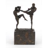 Patinated bronze study of two mixed martial artists raised on rectangular marble base, 26cm high :