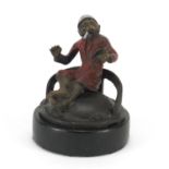 Cold painted bronze figure of a monkey smoking in the style of Franz Xaver Bergmann, raised on a