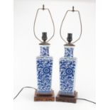 Pair of Chinese blue and white porcelain vases lamps, raised on carved hardwood stands, each