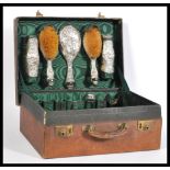 An early 20th Century silver vanity set consisting of two hair brushes, two clothes brushes, a