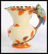 A vintage Wade Heath woodpecker handled jug having hand painted details with makers marks to base.