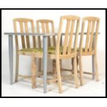 A set of 4 1930's oak dining chairs having contemporary upholstered drop in seats,railed back