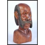 An unusual early 20th century carved wood bust of a gentleman with large moustache. Single carved