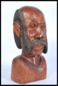An unusual early 20th century carved wood bust of a gentleman with large moustache. Single carved