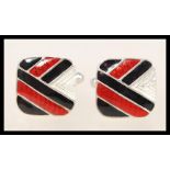 A pair of sterling silver enamel cufflinks having bands of red and black enamel. Weighs 9.2 grams.