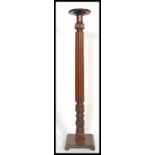 A 19th century Victorian mahogany torchere plant stand of tall form raised on tripod base with
