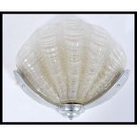 A mid 20th century Art Deco Odeon style frosted glass shell shaped porch wall light lamp being set