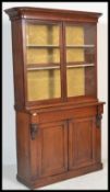 A 19th Century Victorian mahogany library bookcase, the upper recessed section enclosed by a pair of