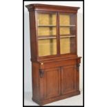 A 19th Century Victorian mahogany library bookcase, the upper recessed section enclosed by a pair of