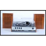 A retro 20th Century Phillips teak cased record player having a smoked acrylic top three speed