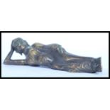A 20th Century bronze figure ornament of a reclining Asian Diety. Measures 23cm high.
