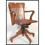 A 1930's Art Deco office Industrial factory swivel  desk chair having a shaped rail back with a