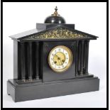 A Victorian 19th century slate and marble mantel clock. Raised on a plinth base with barrel dial and