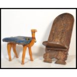 A 20th Century Camel stool modelled as a camel, fitted with a blue leather saddle together with a