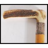 A silver banded hallmarked walking cane, antler handle surmounting a Malacca shaft, the silver