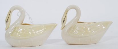 A pair of vintage 20th century Belleek ceramic creamer jugs in the form of swans. Green printed