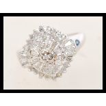 A 9ct white gold Art Deco style cluster ring having approx 50pts of diamonds in a typical Art Deco