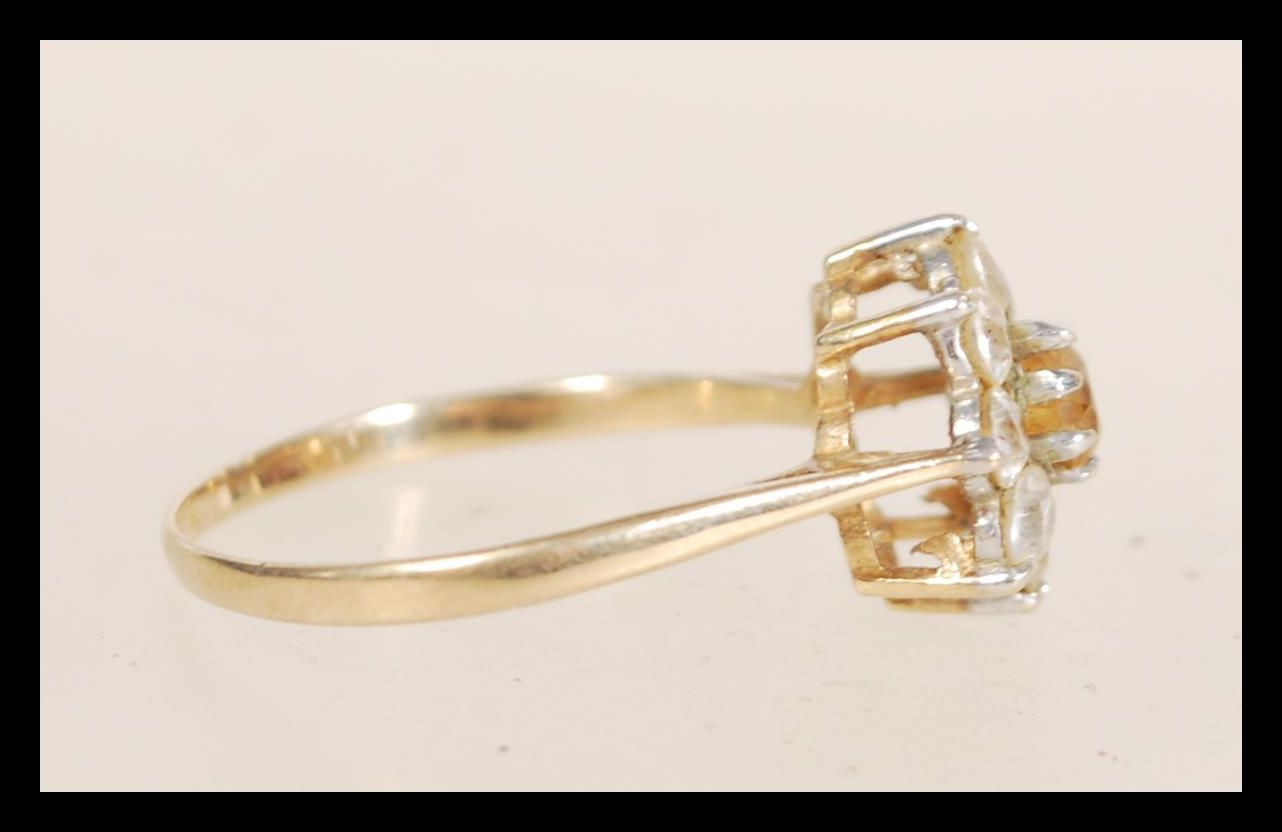 A hallmarked 9ct gold ring set with a central yellow stone flanked by white stones. Hallmarked - Image 2 of 4