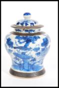 A 19th Century Chinese lidded ginger jar, painted in underglaze blue with peonies and birds of