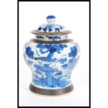 A 19th Century Chinese lidded ginger jar, painted in underglaze blue with peonies and birds of