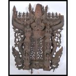 An unusual large Tibetan - Chinese hardwood architectural panel depicting dragons and deity