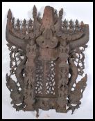 An unusual large Tibetan - Chinese hardwood architectural panel depicting dragons and deity