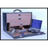 A vintage retro 20th Century doctors bag, fall front opening to reveal three drawers having a