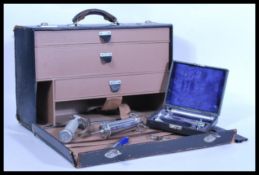 A vintage retro 20th Century doctors bag, fall front opening to reveal three drawers having a
