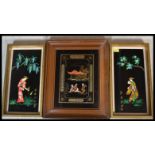 A group of three 20th Century Japanese black lacquer type panels. A pair hand painted on glass