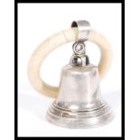 An early 20th Century silver hallmarked childs rattle in the form of a bell on a teething ring.