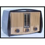 A vintage 20th Century bakelite valve radio by G E C, bakelite knobs and display to the front, Model