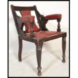 A late 19th / Early 20th Century adjustable Barbers chair, / armchair with red leather upholstered