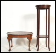 An Edwardian mahogany circular torchere plant stand raised on squared legs with circular top above