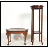 An Edwardian mahogany circular torchere plant stand raised on squared legs with circular top above