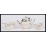 A stamped sterling silver doll's house miniature tea service to include teapot, sugar bowl and