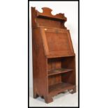 A late 19th century oak arts & crafts student bureau in the manner of Liberty & Co. The fall front