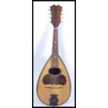 A vintage early 20th Century mandolin musical instrument having rosewood inlay with tortoiseshell