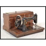 A vintage early 20th Century hand crank cased sewing machine by Teutonia Germany, notation to the