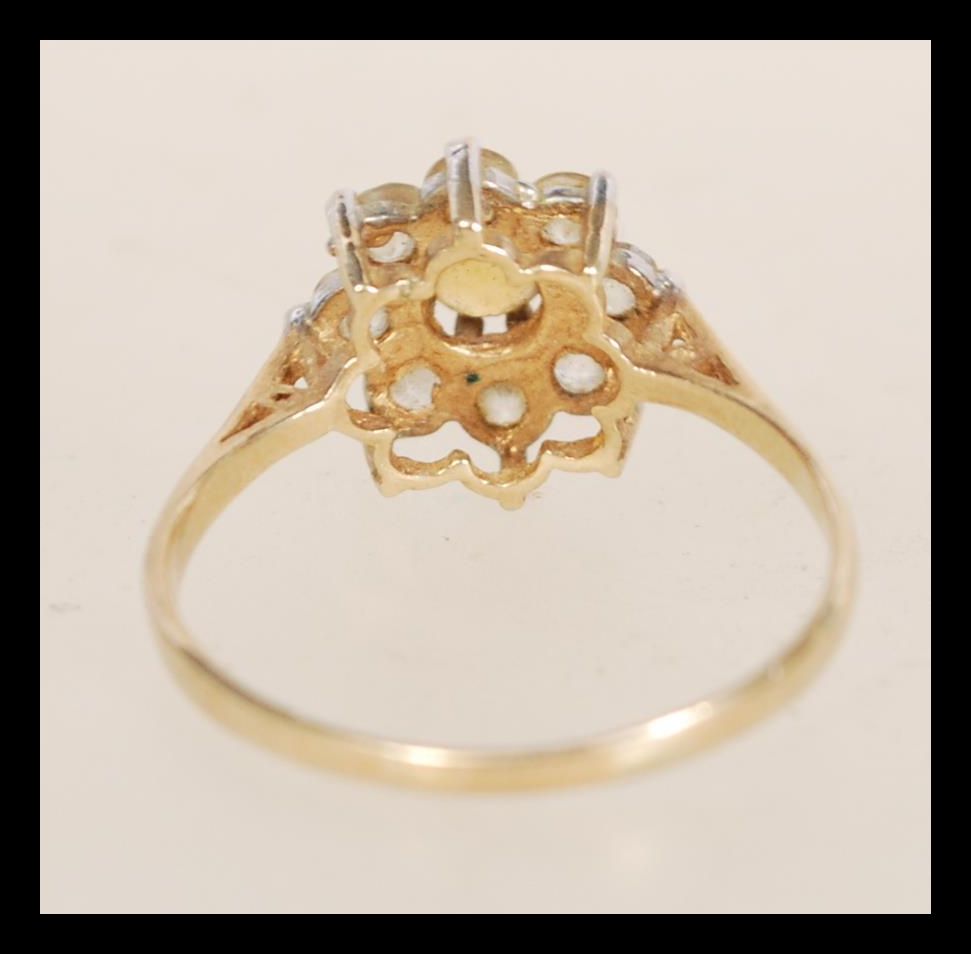 A hallmarked 9ct gold ring set with a central yellow stone flanked by white stones. Hallmarked - Image 3 of 4
