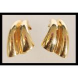 A 15ct gold pair of clip on earrings of double wave form. Weighs 5.6 grams.