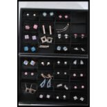 A collection of 30 contemporary designer sterling silver pairs of earrings to include cluster,