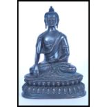 A 19th century Chinese bronze figurine of a Buddha raised on pedestal base and modelled in the lotus