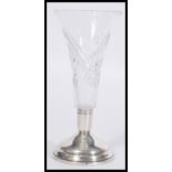 A vintage 20th Century silver hallmarked based cut glass vase raised on a stepped circular base with