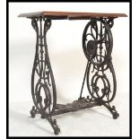 A 19th century  Victorian mahogany and cast iron Singer sewing machine table with decorative cast
