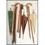 A collection of vintage walking sticks canes from the 20th Century together with a stunning silk